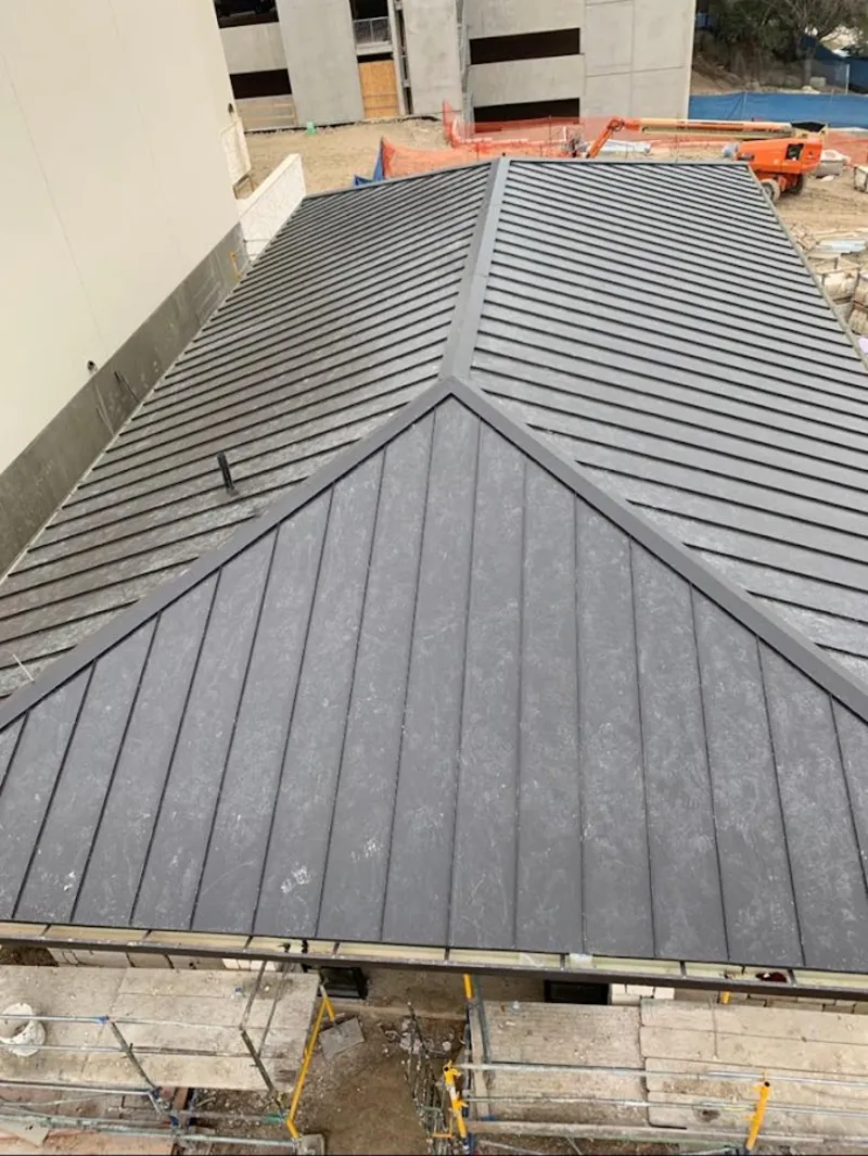 Commercial metal roof construction with crane equipment in Garden Home-Whitford