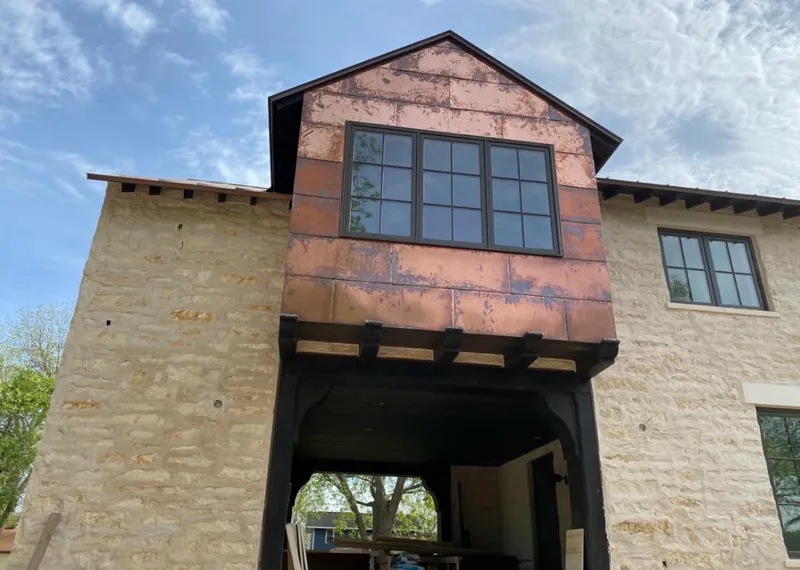 Copper metal panel facade on a stone building for Skylight Installation in Garden Home-Whitford