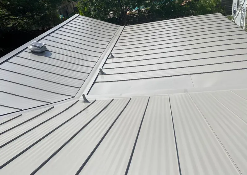 Solar attic fan installed on a metal roof for Roof Ventilation in Garden Home-Whitford